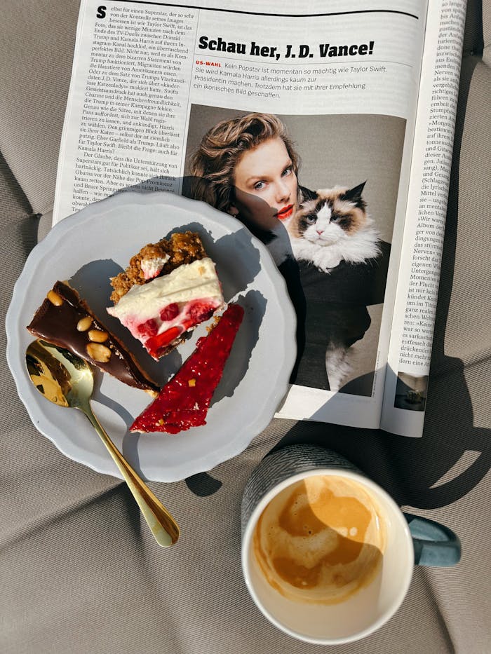 pexels photo 28898171 Artistic plate of desserts and coffee with a fashion magazine in sunlight.